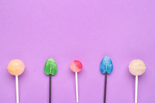 stock image Composition with sweet lollipops on purple background