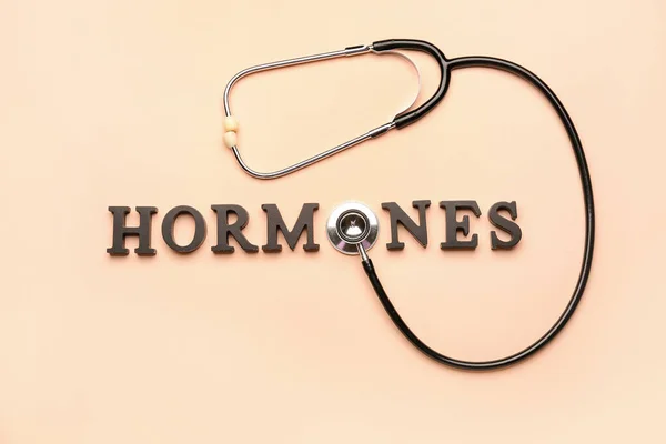 Word Hormones Stethoscope Beige Background — Stock Photo, Image