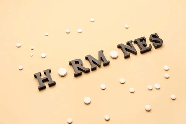 Word Hormones Pills Beige Background — Stock Photo, Image