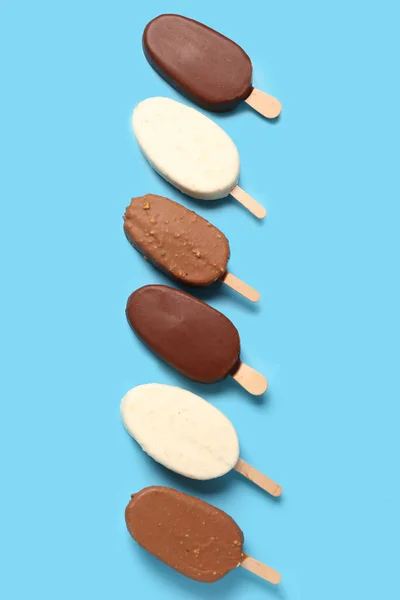 Composition Different Chocolate Covered Ice Cream Stick Blue Background — Stock Photo, Image