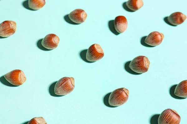 stock image Shelled hazelnuts on blue background, closeup