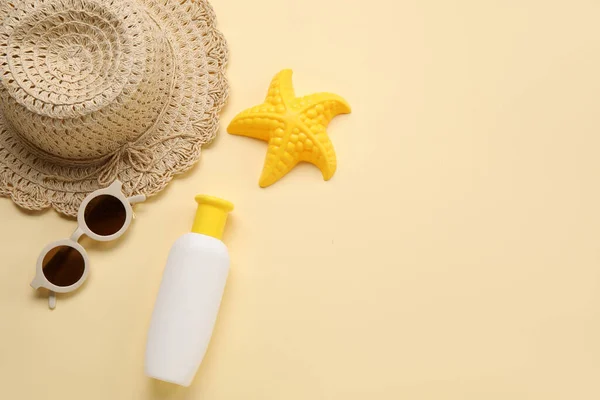 stock image Sunscreen cream for baby with sunglasses, hat and toy on beige background