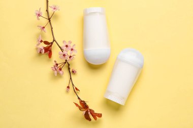 Sarı arkaplanda çiçek açan deodorantlar