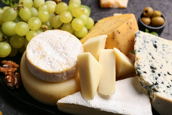 Different types of tasty cheese on table, closeup
