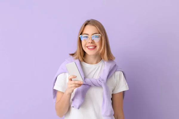 Young Woman Eyeglasses Using Mobile Phone Lilac Background — Zdjęcie stockowe