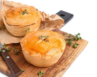 Beyaz arka planda lezzetli etli turtalar olan ahşap tahta tahta, yakın plan.