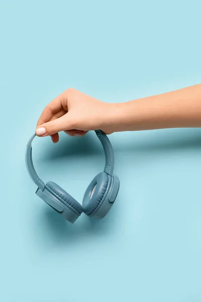 Woman Holding Modern Headphones Blue Background — Stock Photo, Image