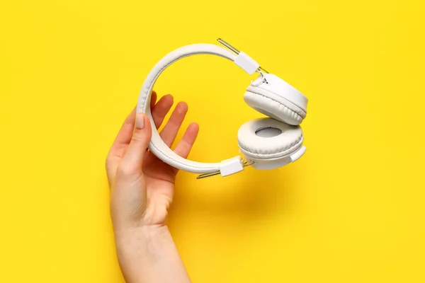 Woman Holding Modern White Headphones Yellow Background — Stock Photo, Image