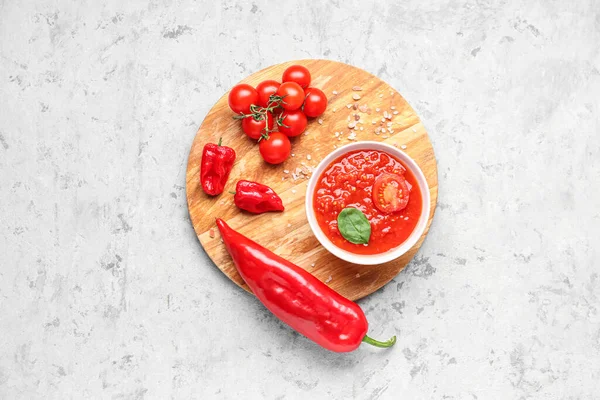 stock image Bowl with tasty tomato sauce and fresh vegetables on grunge background