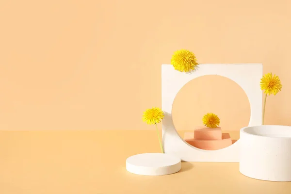 stock image Decorative podiums with dandelion flowers on beige background