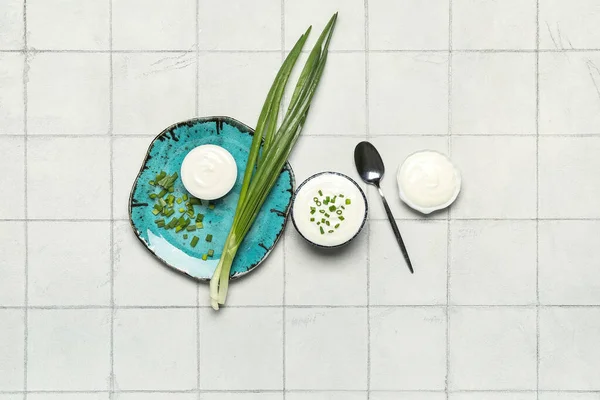 Bowls Tasty Sour Cream Green Onion White Tile Background — Stock Photo, Image