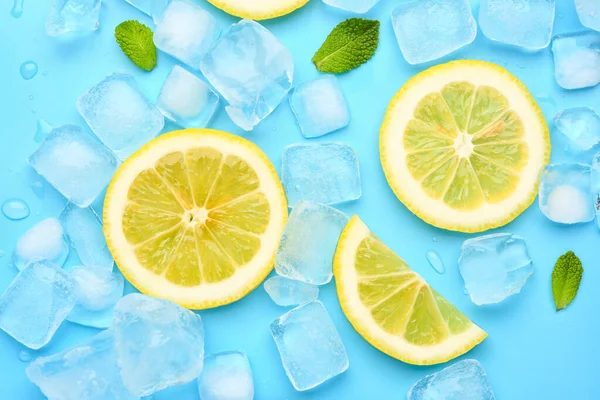 stock image Sliced fresh lemon and ice on blue background