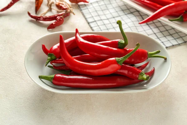 stock image Plate of fresh chili peppers on light background