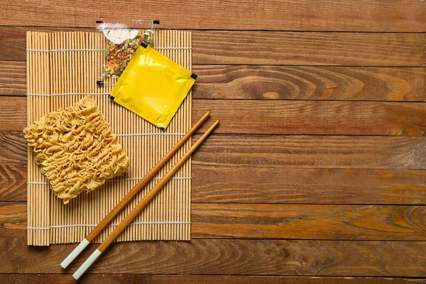 Στρώμα Μπαμπού Ωμά Noodles Καρυκεύματα Και Chopsticks Ξύλινο Φόντο — Φωτογραφία Αρχείου