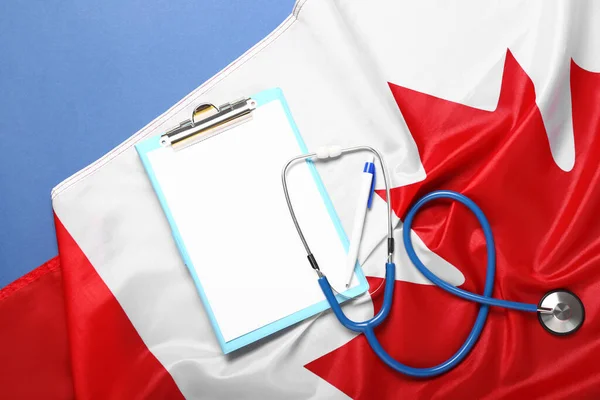 Clipboard Stethoscope Flag Canada Blue Background — Stock Photo, Image