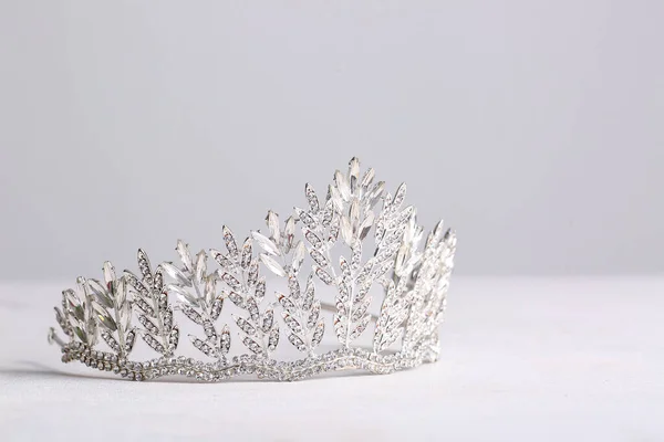 stock image Beautiful tiara on white table, closeup. Prom concept