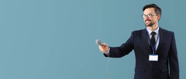 Mavi arkaplanda mikrofonu olan, metin için alanı olan erkek gazeteci