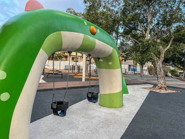 stock image View of children's complex with swings on playground