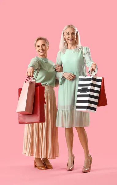 Volwassen Vrouwen Met Boodschappentassen Roze Achtergrond — Stockfoto