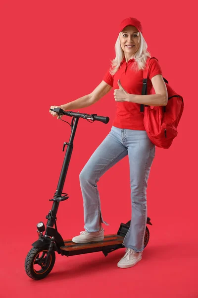 Mature Courier Electric Bike Showing Thumb Red Background — Stock Photo, Image