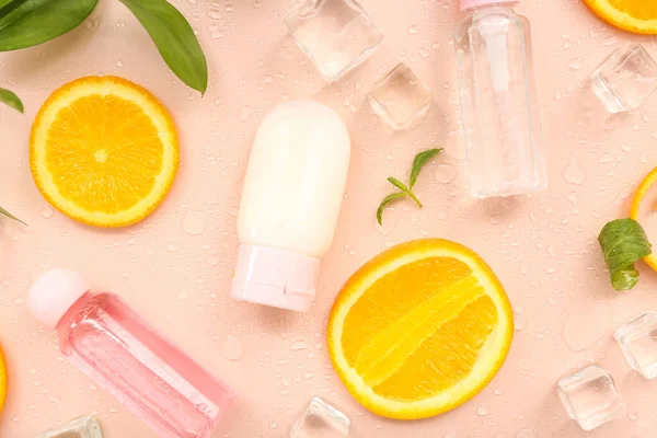 Cosmetic Bottles Orange Slices Ice Cubes Mint Beige Background — Stock Photo, Image