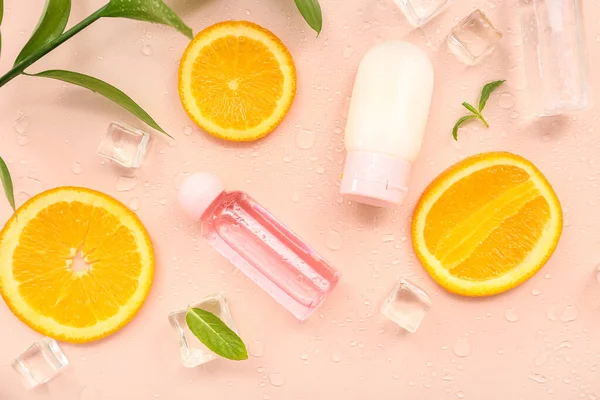 Cosmetic Bottles Orange Slices Ice Cubes Mint Beige Background — Stock Photo, Image