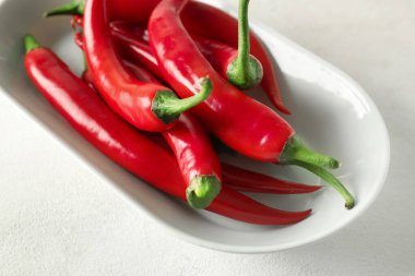 Arka planda taze kırmızı biber tabağı, yakın plan.