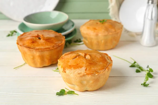 stock image Tasty meat pot pies on table