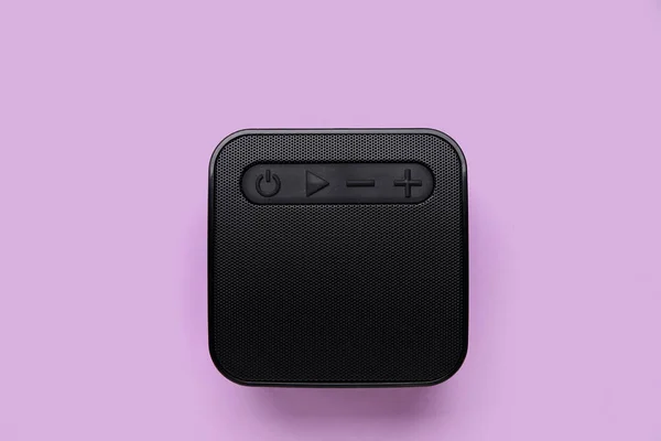 Modern wireless speaker on purple background