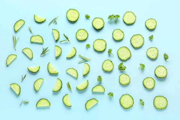 stock image Slices of cucumber with rosemary and parsley on turquoise background