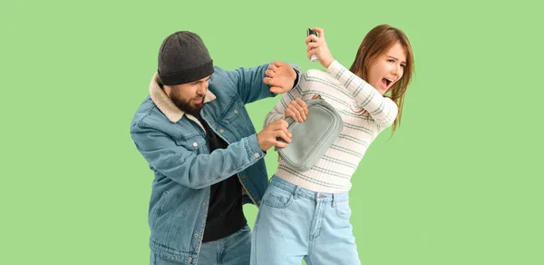 Young Woman Pepper Spray Defending Herself Thief Green Background — Foto de Stock