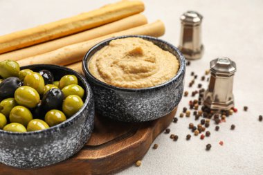 Lezzetli humus tabakları ve hafif arka planda zeytinler, yakın plan.