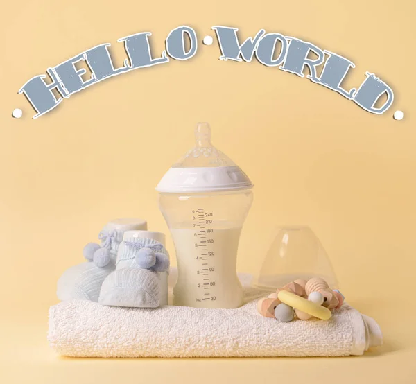 Banner with text HELLO WORLD and baby accessories