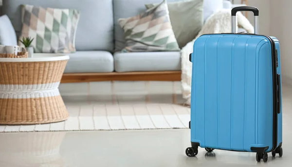 Blue packed suitcase in room. Travel concept