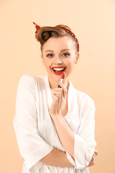Young Pin Woman Applying Red Lipstick Beige Background — Stock Photo, Image