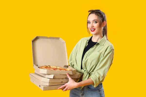 Young Woman Cardboard Boxes Tasty Pizza Yellow Background — Zdjęcie stockowe