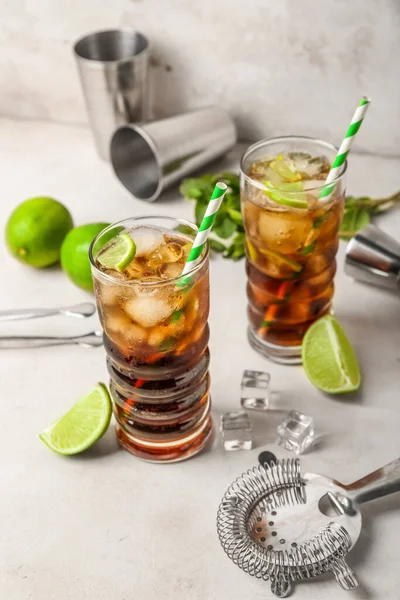 stock image Glasses of cold Cuba Libre cocktail on light background