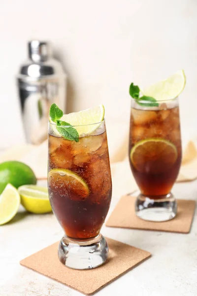 stock image Glasses of cold Cuba Libre cocktail on light background