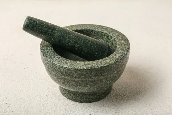 Mortar and pestle on light background