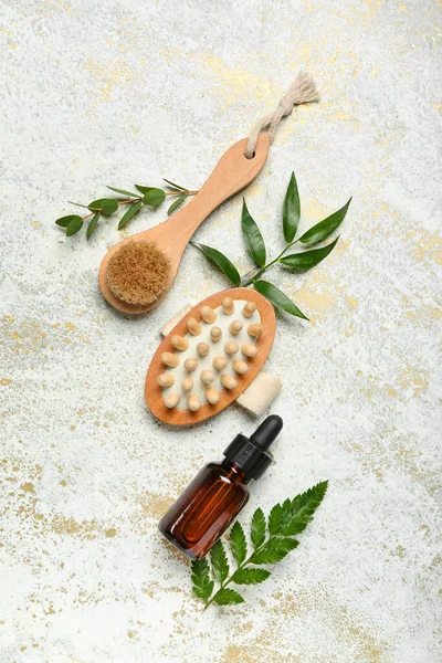 Bottle Cosmetic Oil Plant Twigs Massage Brushes Grunge Background — Stock Photo, Image