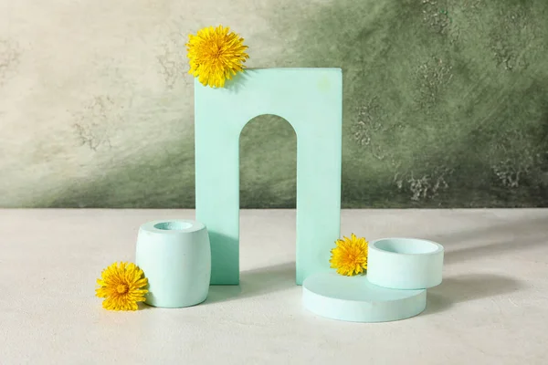 Stock image Decorative podiums with dandelion flowers on grey grunge background