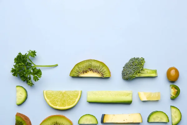 stock image Composition with green fresh fruits and vegetables on blue background