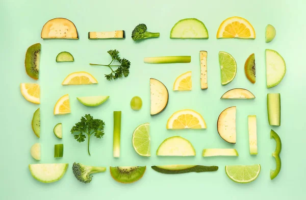 stock image Composition with different fresh green vegetables and fruits on pale green background