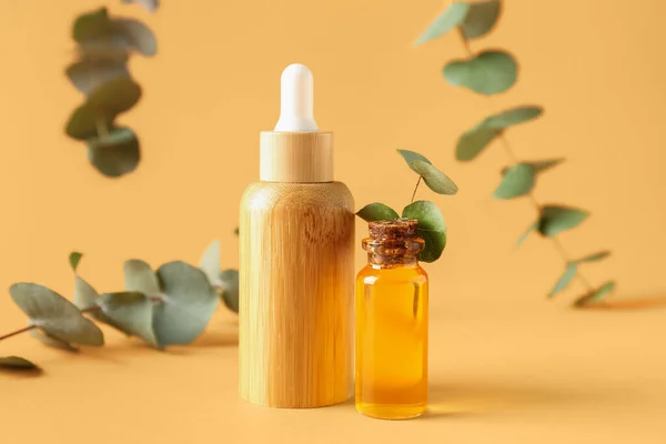 Bottles Cosmetic Oil Eucalyptus Branches Yellow Background — Stock Photo, Image
