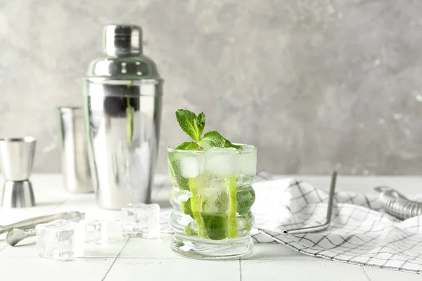 stock image Glass of tasty mojito on table