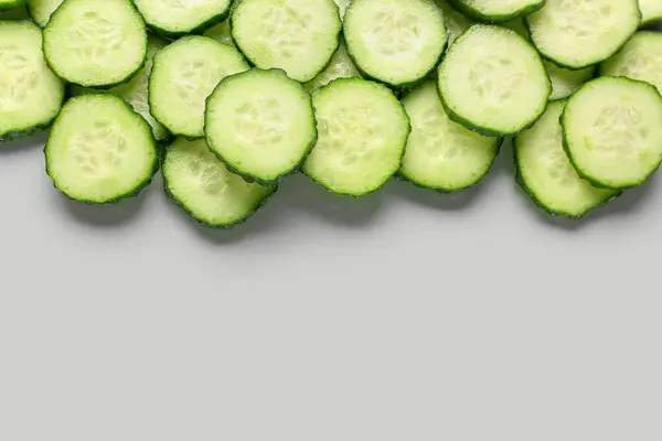 Stock image Slices of cucumber on grey background