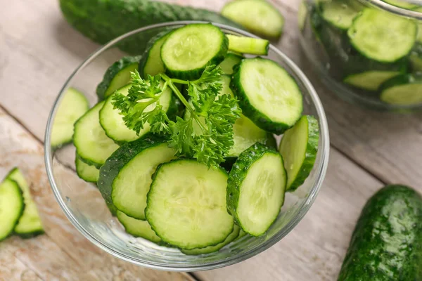 Bowl Fresh Cut Cucumbers Light Wooden Background Closeup — Stock Photo, Image