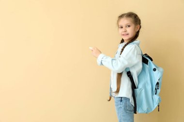 Bej arka planda tebeşir parçası olan küçük bir kız öğrenci. Çocuk Bayramı kutlaması