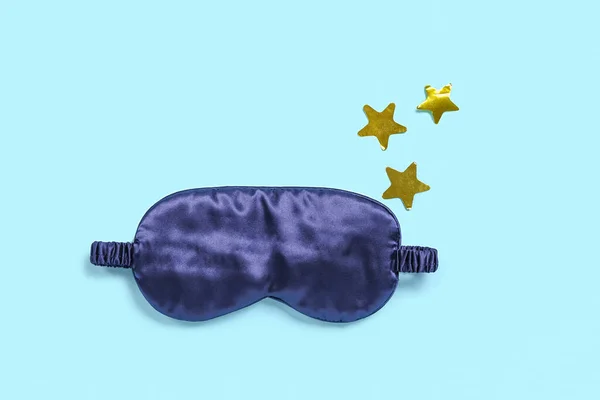 Sleeping mask and stars on blue background