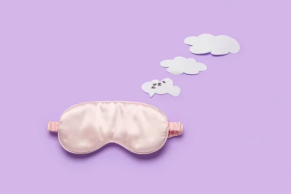 Sleeping masks and speech bubbles on lilac background